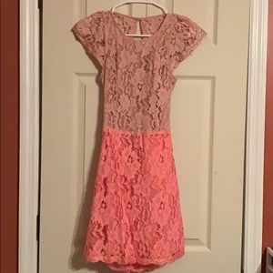 Nude/pink lace dress with open back detail.